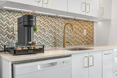 a kitchen with a sink and a stove at Charming lakeview suite with parking in Toronto