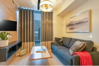a living room with a couch and a table at Cozy 2BD Near UW in Waterloo