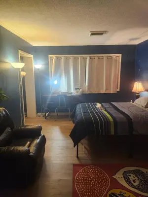 a bedroom with a bed and a couch and a window at House near University of Waterloo, Perimeter Institute, Wilfred Laurier University in Waterloo