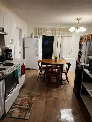 a kitchen with a table and a kitchen with a refrigerator at House near University of Waterloo, Perimeter Institute, Wilfred Laurier University in Waterloo