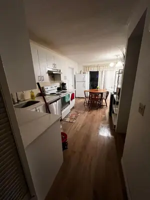 a kitchen with white cabinets and a wooden floor at House near University of Waterloo, Perimeter Institute, Wilfred Laurier University in Waterloo