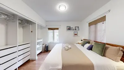 a bedroom with a large bed and a window at Liberty Village-BMO Field-Roof Patio-Parking in Toronto