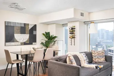 a living room with a couch and a table at Centrally located 2 Bd 2 Bth + Parking in Toronto