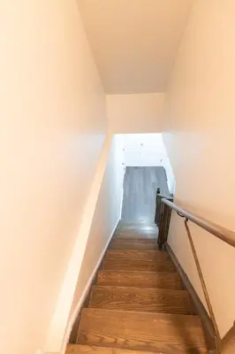 a staircase in a house with wooden floors at New Basement Apartment with parking in Oakville