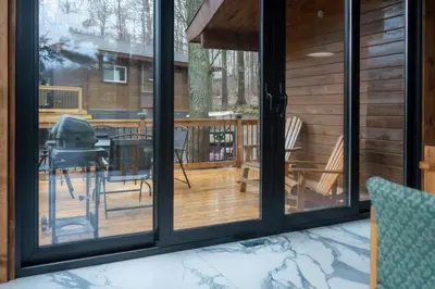 a screened in porch with a view of a deck at Stunning Lakeview Muskoka Pier 100 Resort in Port Carling