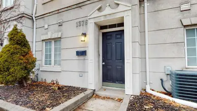 a house with a blue door and a tree at Modern & Spacious Midtown Toronto Family Home in Toronto