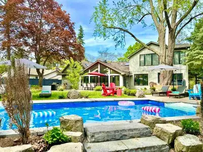 a home with a swimming pool and a yard at The Serenity Home Pool/Yoga/Game Room by the Lake in Mississauga