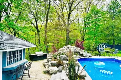 a backyard with a swimming pool and a house at The Serenity Home Pool/Yoga/Game Room by the Lake in Mississauga