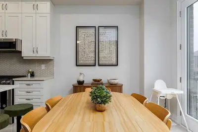 a kitchen with a wooden table with a potted plant on it at Elegant Five Bedroom Home Designed for Comfort and Space in Oakville