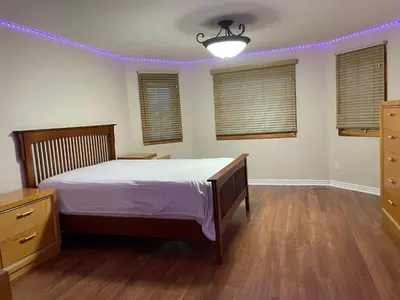 a bedroom with a bed with purple lights on it at Luxury room at southern Guelph in Guelph