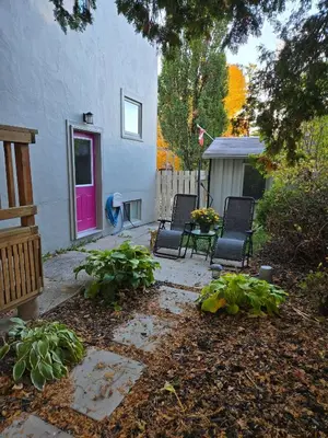 a patio with two chairs and a table in a yard at Cozy East Hill 2026 in Belleville