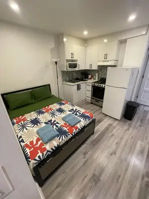 a small kitchen with a bed in a room at DOWNTOWN-BMO Field Stay-Next to Transit-Restaurants-Union Station in Toronto