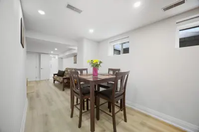 a dining room with a table and chairs at Charming Streetsville 2 Bedroom Suite with Parking and Laundry in Mississauga