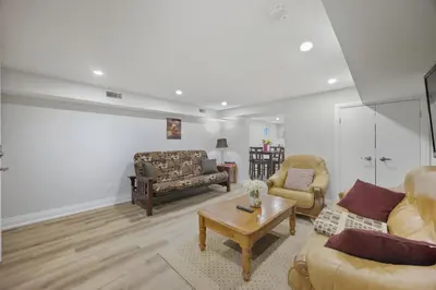 a living room with two couches and a coffee table at Charming Streetsville 2 Bedroom Suite with Parking and Laundry in Mississauga
