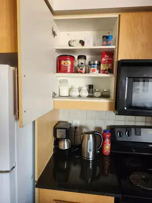 a kitchen with a coffee maker on a counter next to a microwave at 2 Bedroom Luxury Suite Across Square One in Mississauga