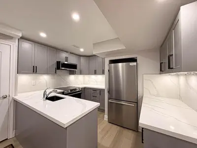 a kitchen with a stainless steel refrigerator and cabinets at Blessed Home in Milton