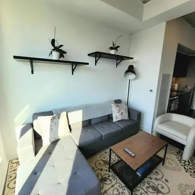 a living room with a couch and a table at Feel at home Spacious Industrial Style, 2bed 2bath in Toronto