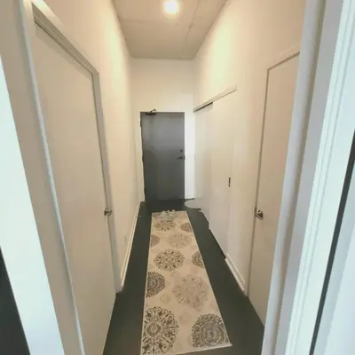 a hallway with two doors and a carpet at Feel at home Spacious Industrial Style, 2bed 2bath in Toronto