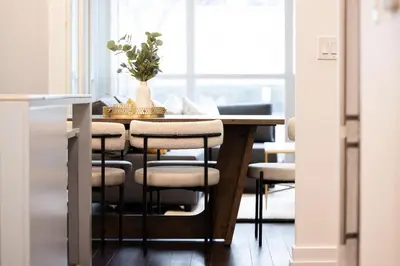 a dining room table with chairs and a vase on it at Lux Harbourfront Home Sleeps 10 with Free Parking in Toronto