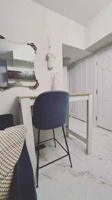 a blue chair in a white kitchen with a table at Grimsby on the Lake sweet, your perfect retreat in Grimsby