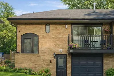 a brick house with a black garage at Executive Urban Retreat in Brampton
