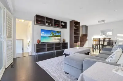 a living room with a couch and a tv at Executive Urban Retreat in Brampton