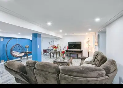 a living room with a couch and a tv at A very peaceful home in Oshawa