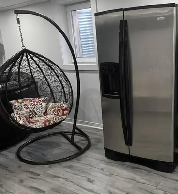 a swing in a kitchen next to a refrigerator at A very peaceful home in Oshawa