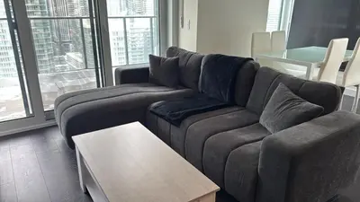 a living room with a couch and a table at Luxury Condo Downtown Toronto in Toronto