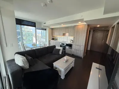 a living room with a couch and a table at Luxury Condo Downtown Toronto in Toronto