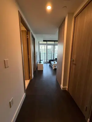 a hallway leading to a room with a living room at Luxury Condo Downtown Toronto in Toronto