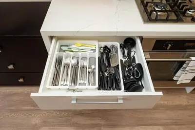a white drawer filled with utensils in a kitchen at Winter Deal! Modern 4BR w/Parking, Prime Location in Toronto