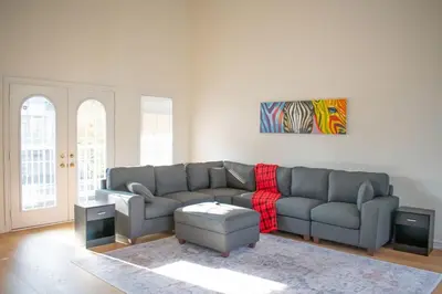 a living room with a couch and a rug at Karibu Home Retreat, 5 min to Ontario Largest Spa in Ajax