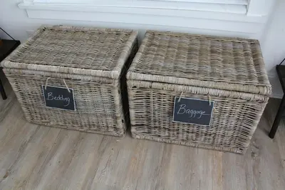 two wicker baskets sitting on top of a floor at Prime Waterfront Cottage on Sandbanks Area Resort in Cherry Valley