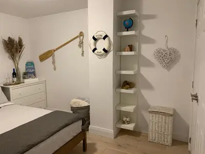 a bedroom with a bed and white shelves at Parkside Modern Retreat in Mississauga
