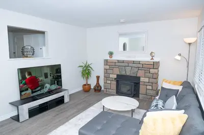 a living room with a couch and a fireplace at Cozy Bungalow Near Niagara Falls - Perfect Family Retreat in Niagara Falls