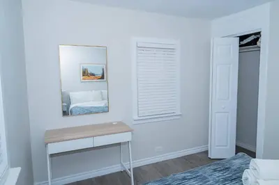 a bedroom with a mirror and a table and a bed at Cozy Bungalow Near Niagara Falls - Perfect Family Retreat in Niagara Falls