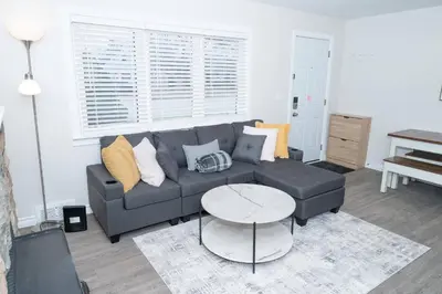a living room with a couch and a table at Cozy Bungalow Near Niagara Falls - Perfect Family Retreat in Niagara Falls