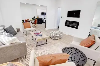 a living room with a couch and a table at 5 bedrooms for large groups near the falls in Port Colborne