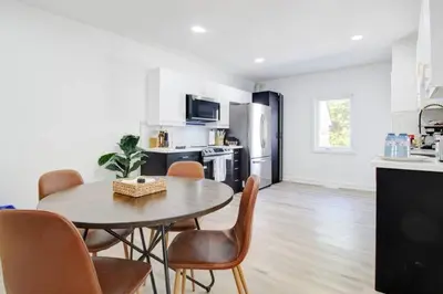 a kitchen with a table and chairs in a room at 5 bedrooms for large groups near the falls in Port Colborne