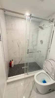 a bathroom with a shower with a toilet at 2 Bed Newly Renovated unit near Falls and Buffalo in Port Colborne