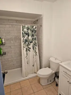 a bathroom with a toilet and a shower curtain at Central Signature Stay Downtown-Direct Transit to BMO Field Union & Free Wifi in Toronto
