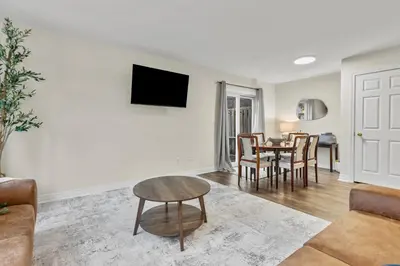 a living room with a couch and a table at Chelsea Suite 3BR, 1B with parking for 28plus stays in St. Catharines