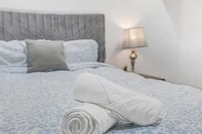 a rolled up towel sitting on top of a bed at 166 Basement - Cozy 3BR Markham Stay, Patio, Parking, Pet-Free in Markham