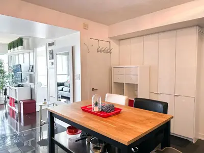 a kitchen and dining room with a wooden table at CityPlace Lofts Free Parking in Toronto