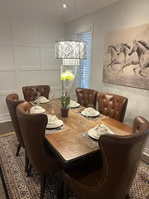 a dining room with a wooden table and brown chairs at Warm Stylish 4 Bedroom Home 3 Bath in Ajax