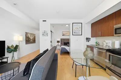 a living room with a couch and a table at Downtown Toronto CN Tower Condo in Toronto