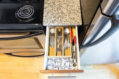 a kitchen counter with utensils in a holder at Downtown Toronto CN Tower Condo in Toronto