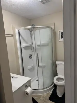 a bathroom with a shower and a toilet at Gorgeous 3-Bedroom 3Bathroom house in Kitchener
