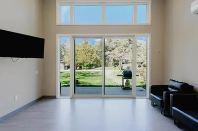 an empty living room with a sliding glass door at Lakefront Englewood Villas Private BBQ and Lakeview in Lakefield